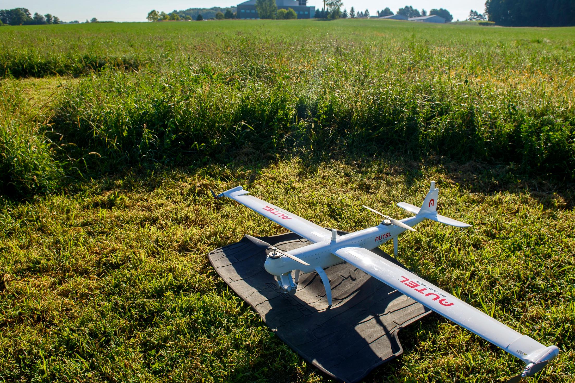 A large drone parked in a field