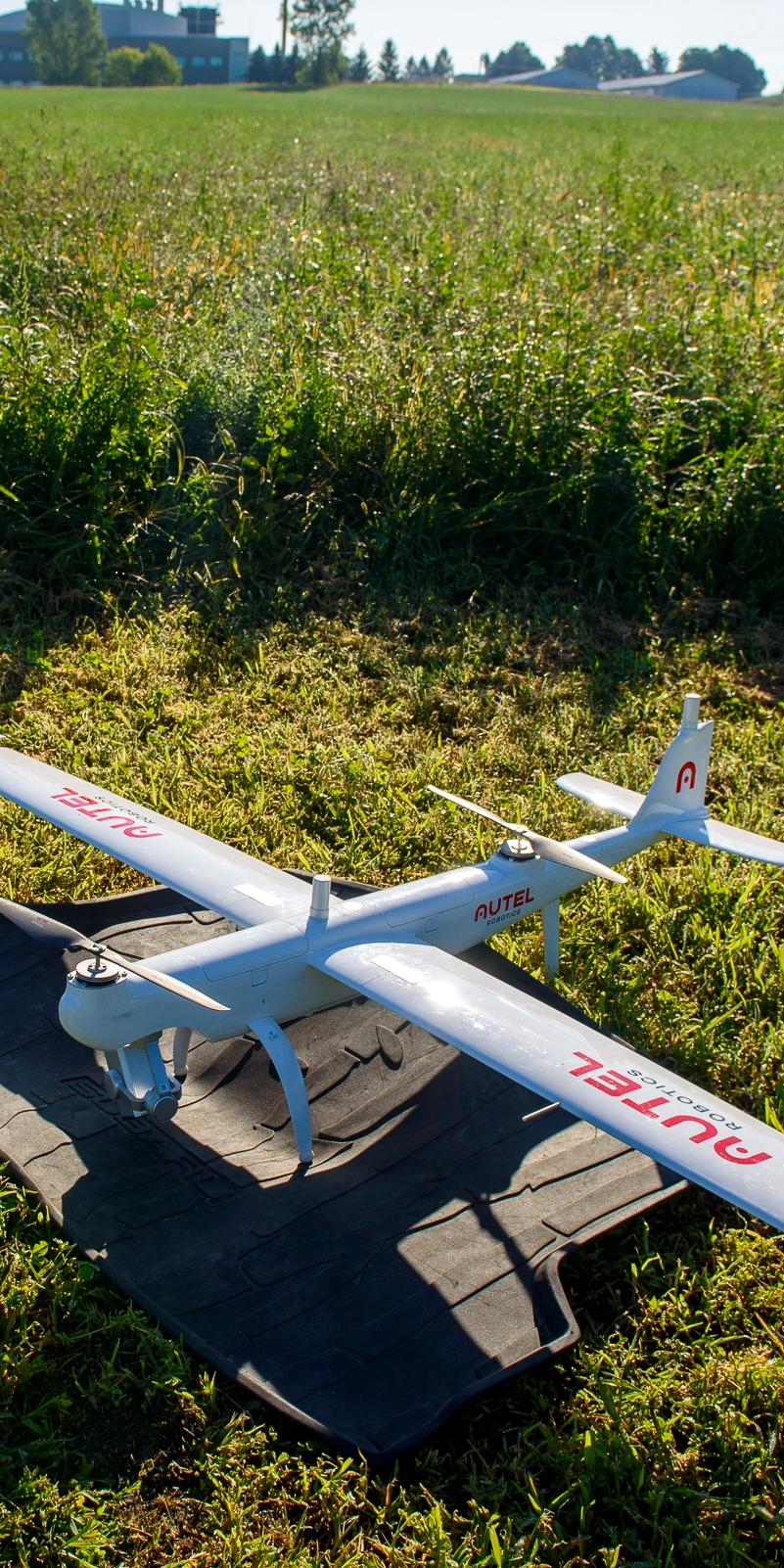 A large drone parked in a field