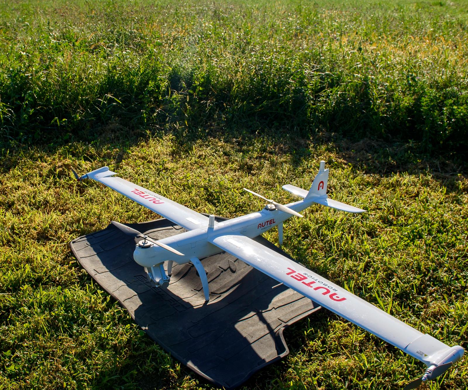 A large drone parked in a field